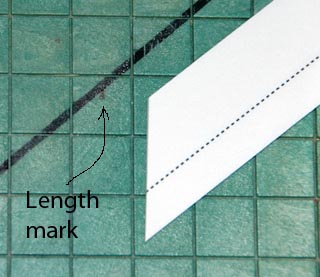 Align top corner of patch with the cut guide line and the length mark.